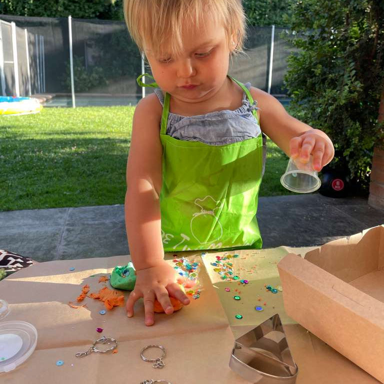 niña construyendo llaveros con masa